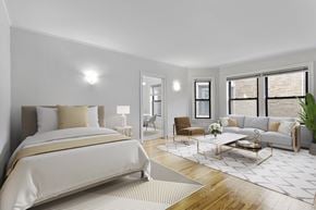 Chicago apartment for rent - A well-lit bedroom with a large bed and a couch.