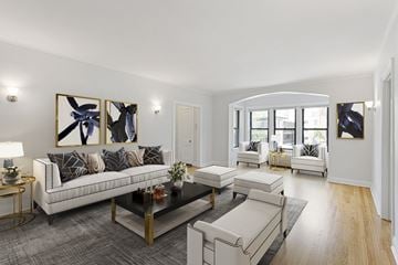 Chicago apartment for rent - A modern living room with a white sofa, a coffee table, and a painting on the wall.