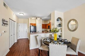 Peoria apartment for rent - A dining room with a table set for two and a television in the background.
