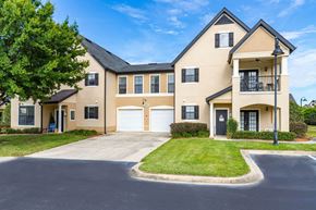 Gainesville apartment for rent - Spacious Grounds | Park Lane Apartments in Gainesville Exterior two story building with patio. Carriage home with private entry and grass surround.