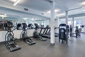Norwalk apartment for rent - The Beacon fitness center with cardio and weight machines, yoga balls, and a mirror wall