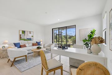 Sarasota apartment for rent - A well-lit, modern living room with a white sofa set, a wooden chair, and a dining table with chairs.