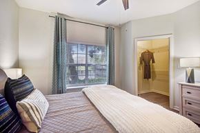 Orlando apartment for rent - A bedroom with a large bed and a window with blinds.