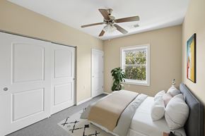 Independence apartment for rent - A bedroom with a bed, pillows, a ceiling fan, and a window.