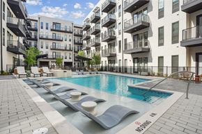 Irving apartment for rent - A pool surrounded by apartment buildings with a no swimming sign.