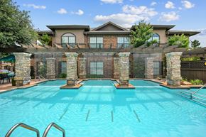 Mckinney apartment for rent - a swimming pool with a house in the background