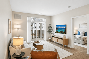 Groveland apartment for rent - A well-lit living room with a brown chair and a white couch.