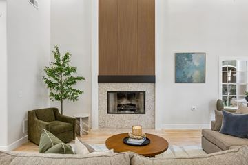 Richardson apartment for rent - A living room with a fireplace and a painting on the wall.