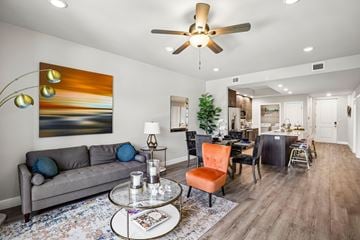 Fort Myers apartment for rent - A living room with a grey couch, a coffee table, and a painting on the wall.