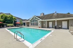 Carlisle apartment for rent - A swimming pool in a residential area with a house in the background.
