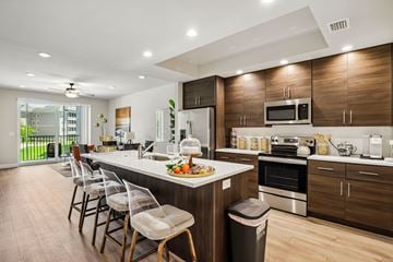 Fort Myers apartment for rent - A modern kitchen with a long island and chairs.