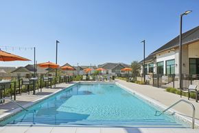 Fort Worth apartment for rent - A large swimming pool with a metal fence around it.