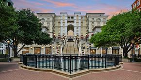 San Antonio apartment for rent - A large building with a pool in front of it.