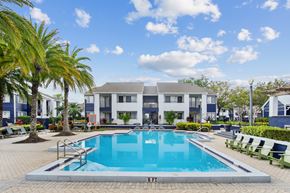 Winter Park apartment for rent - a swimming pool in front of a building with a resort style pool