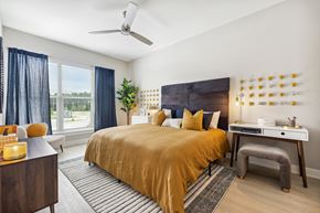 Summerville apartment for rent - a bedroom with a large bed and a desk with a chair