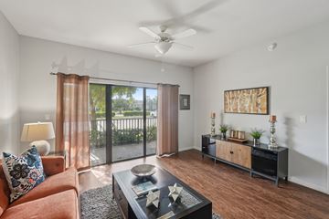 Fort Myers apartment for rent - A living room with a brown couch and a black coffee table.