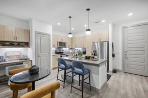 Dallas apartment for rent - A modern kitchen with a dining table and chairs.