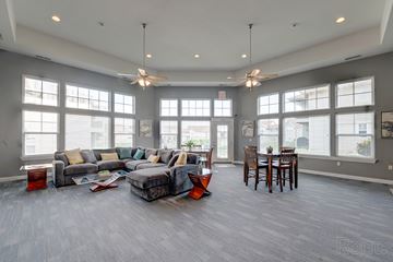 Lawrence apartment for rent - A spacious living room with a grey couch and a grey floor.