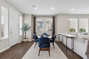 Fort Worth apartment for rent - A dining room with a table set for two and a couch in the background.
