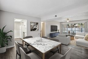 Tampa apartment for rent - A modern dining room with a large table and chairs.