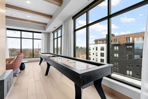 Minneapolis apartment for rent - A pool table in a room with a view of the city.