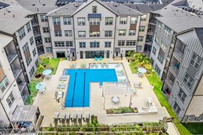 Austin apartment for rent - an aerial view of an apartment building with a swimming pool