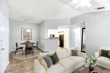 Fort Worth apartment for rent - A living room with a white couch and a dining table.