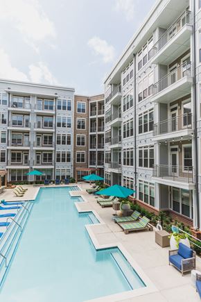 Atlanta apartment for rent - A large swimming pool surrounded by apartment buildings.