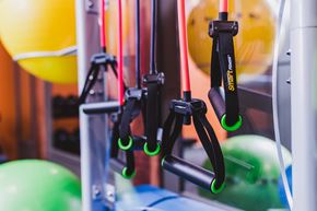 Atlanta apartment for rent - A set of black and green gym equipment hangs in front of a yellow and green exercise ball.