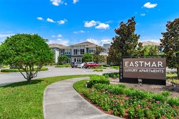 Orlando apartment for rent - A sign for Eastmar Luxury Apartments is in front of a building and some trees.