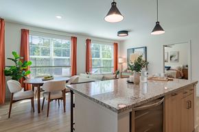 Chelmsford apartment for rent - A kitchen with a table and chairs in front of a window.