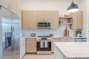 Peabody apartment for rent - A modern kitchen with wooden cabinets and stainless steel appliances.