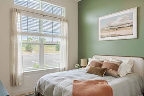 Peabody apartment for rent - A bedroom with a large bed and a painting of a beach scene on the wall.