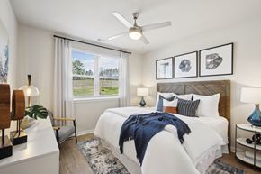 Fairburn apartment for rent - a bedroom with a large bed and a ceiling fan