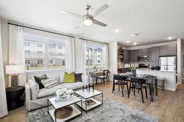 Fairburn apartment for rent - A modern living room with a glass coffee table and a dining table with chairs.