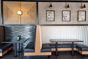 Chicago apartment for rent - A modern dining area with a wooden table and black leather chairs.