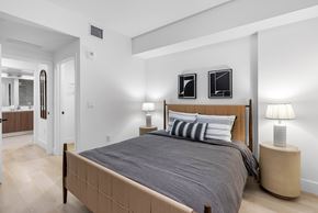 Miami apartment for rent - A bedroom with a large bed and two lamps.