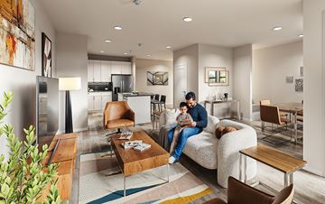 Tomball apartment for rent - A man and a child are sitting on a couch in a modern living room.