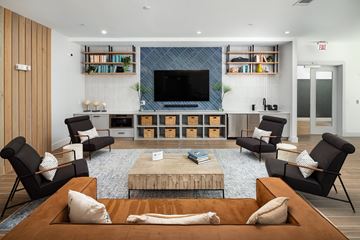 Morrisville apartment for rent - A living room with a wooden floor and a large television on the wall.