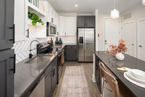 Morrisville apartment for rent - A kitchen with a black counter top and stainless steel appliances.