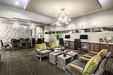 Dallas apartment for rent - A modern living room with a patterned carpet and a variety of seating options.