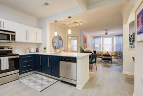 Laurel apartment for rent - a kitchen with blue and white cabinets and a white counter top
