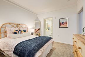 Laurel apartment for rent - a bedroom with a bed and a dresser and a bathroom