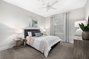 Charleston apartment for rent - a bedroom with a bed and a ceiling fan