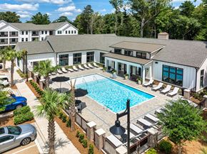 Charleston apartment for rent - an aerial view of a swimming pool in front of a building with a pool house