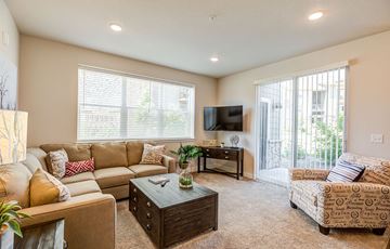 Fort Collins apartment for rent - A living room with a tan couch and a brown coffee table.