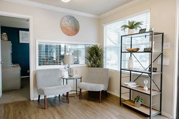 San Antonio apartment for rent - A living room with a grey chair and a small table.