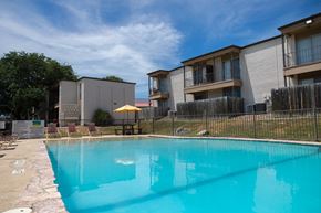 San Antonio apartment for rent - A swimming pool in front of apartment buildings.