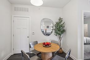 Nashville apartment for rent - a dining room with a table and chairs and a mirror