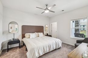 Nashville apartment for rent - a bedroom with a large bed and a ceiling fan